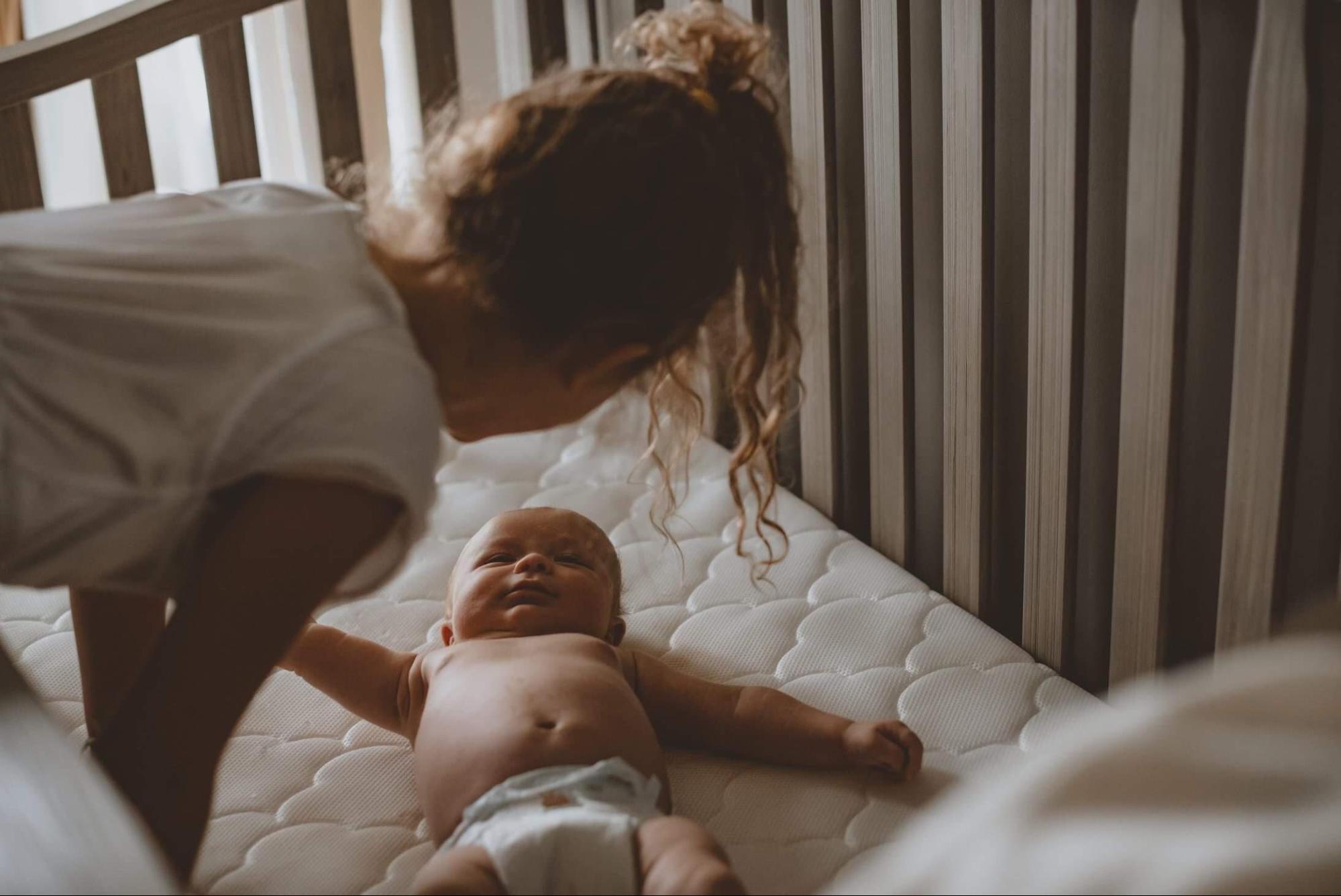 Newborn baby in a crib hotsell