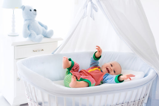 Baby sleeping on a bassinet mattress