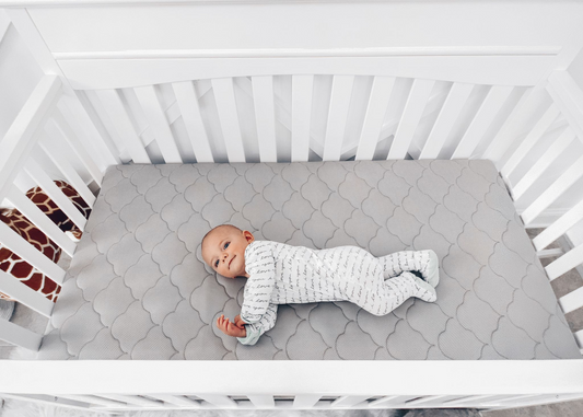 baby sleeping on crib mattress