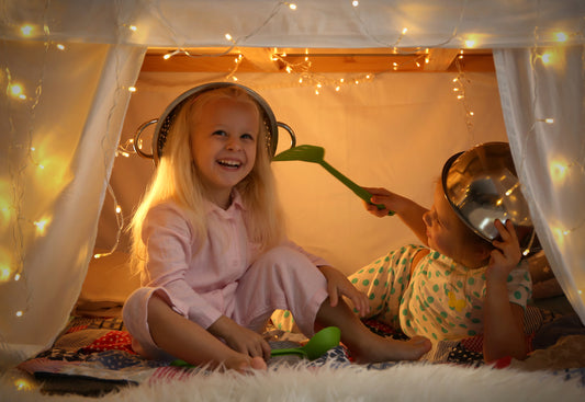 Siblings playing in a kids fort