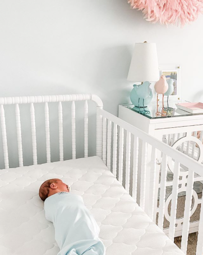 Baby swaddled in crib for perfect baby sleep environment