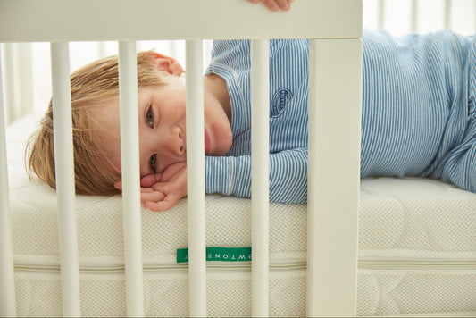 Kid sleeping on a toddler mattress