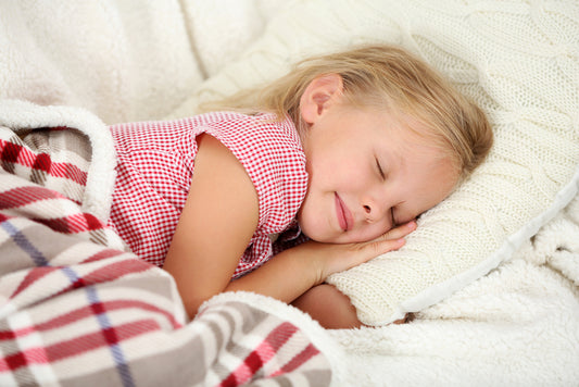 Young girl sleeping on twin mattress for kids