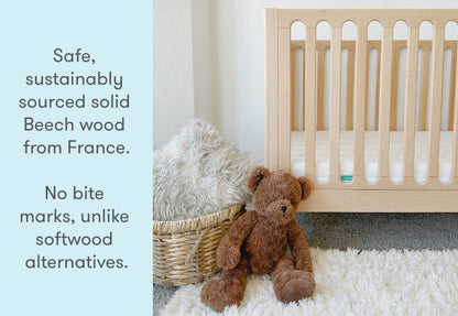 newton galileo crib in natural color in a nursery with stuffed animals, text reads "safe, sustainably sourced solid beech wood from France. No bite marks, unlike softwood alternatives.