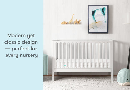 newton galileo crib in white in a modern nursery, text reads "modern yet classic design -- perfect for every nursery"