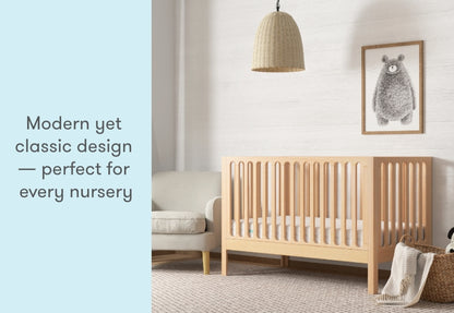 angled image of the newton galileo crib in natural color in a modern nursery, text reads "modern yet classic design -- perfect for every nursery